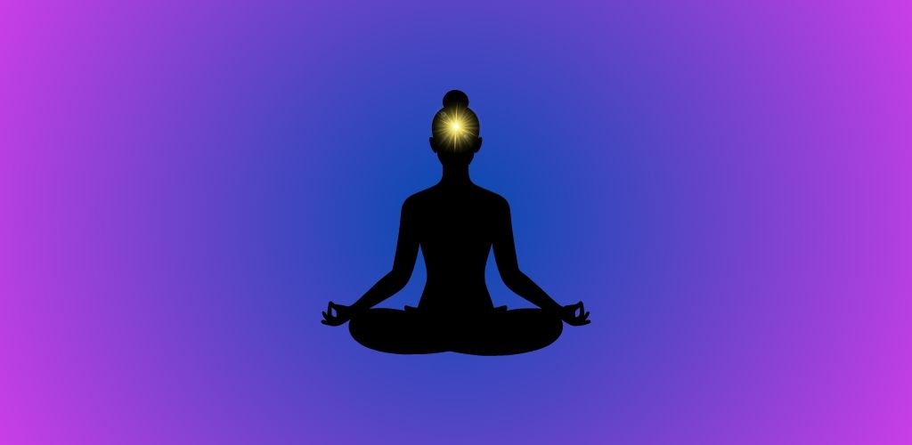 An illustration of the Ajna chakra showing a glowing indigo light at the forehead, symbolizing balanced inner vision, intuition, and spiritual awareness.