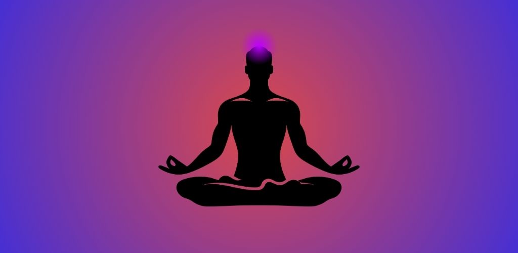 Silhouette of a person meditating in lotus position with a glowing crown chakra on top of the head, set against a purple and pink gradient background.